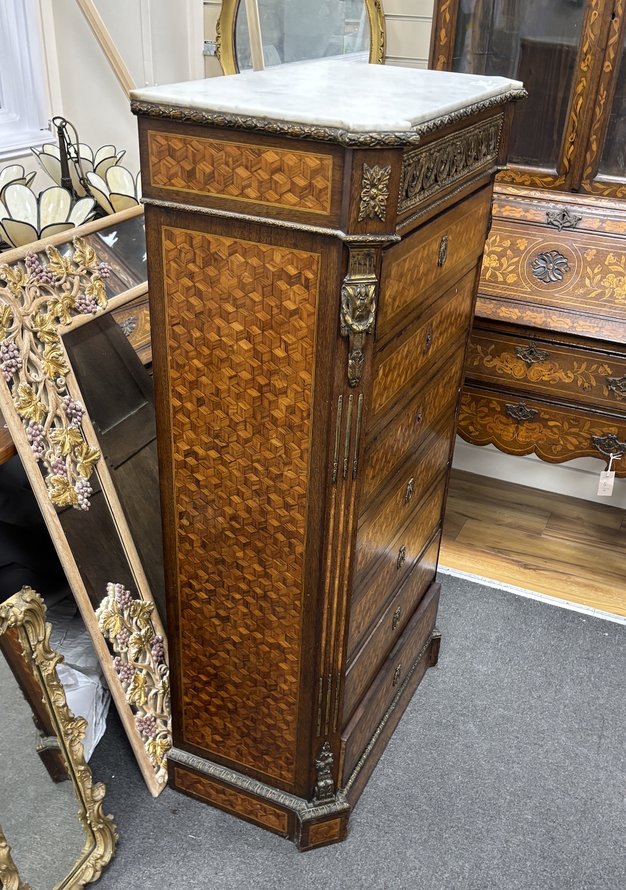 A 19th century French Transitional style parquetry inlaid semanier, gilt metal mounted with white marble top, width 70cm, depth 38cm, height 128cm